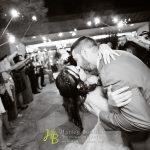 A man and woman kissing on the dance floor.